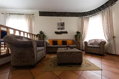 a living room with a couch and two chairs at Casa Nunes in Santana