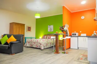 a bedroom with an orange and green wall at Casa Nunes in Santana