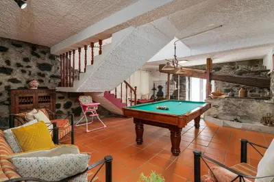 a living room with a pool table in it at Gouveia Cottage in Seixal