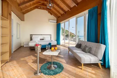 a living room with a couch and a bed at TarmarPlace in Jardim do Mar