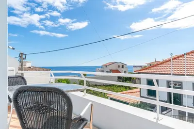 a balcony with chairs and a view of the ocean at TarmarPlace in Jardim do Mar