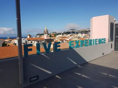 a sign on the roof of a building that reads love experience at Five Design Rooftop by Storytellers in Funchal