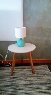 a small table with a lamp on top of a rug at Five Design Rooftop by Storytellers in Funchal
