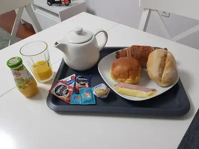 a black tray with a plate of food and a teapot at Five Design Rooftop by Storytellers in Funchal