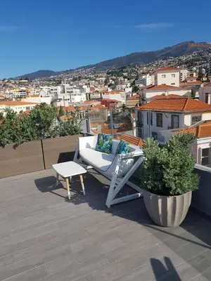 a white chair sitting on top of a roof at Five Design Rooftop by Storytellers in Funchal