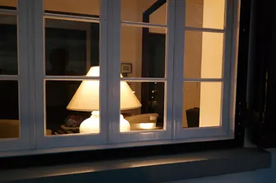 a lamp is seen through a window at Quinta B. in Funchal