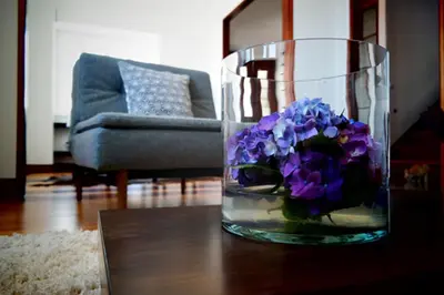 a vase filled with purple flowers sitting on a table at Quinta B. in Funchal