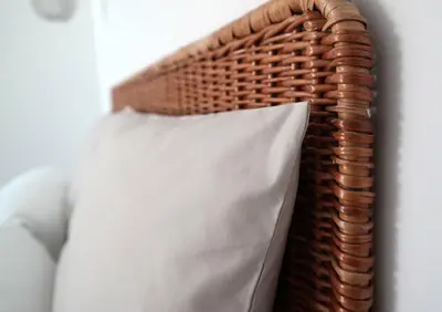 a pillow sits on a wicker basket at Quinta B. in Funchal