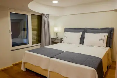 a bedroom with a large bed and a window at Apartments Madeira City Center in Funchal