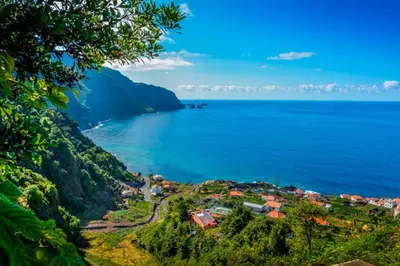 a small town on a hill next to the ocean at Enzo Apartament in Funchal
