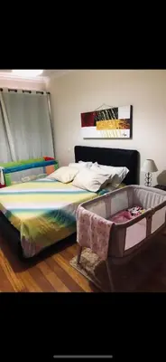 a bedroom with a large bed with a headboard at Enzo Apartament in Funchal