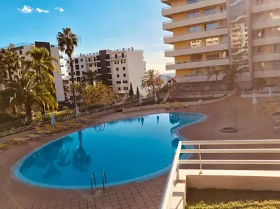 a large swimming pool in a city with buildings at Enzo Apartament in Funchal