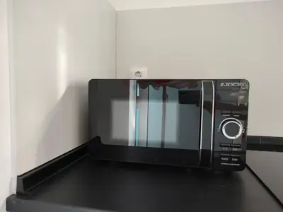 a microwave oven sitting on top of a counter at Madeira Blue House in Calheta