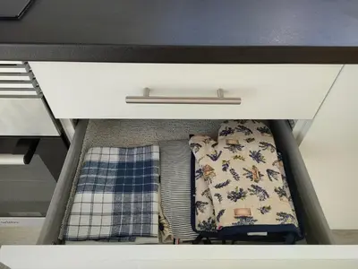 an open drawer with two blankets and a mattress at Madeira Blue House in Calheta