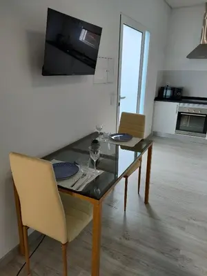 a dining room with a glass table and chairs at Madeira Blue House in Calheta