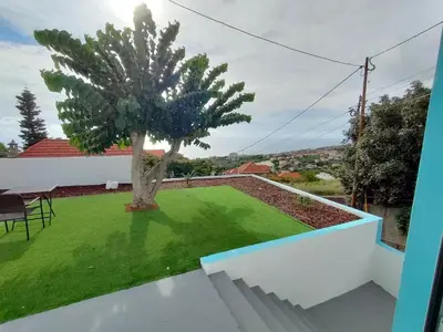 a view from the balcony of a house with a tree at Madeira Blue House in Calheta