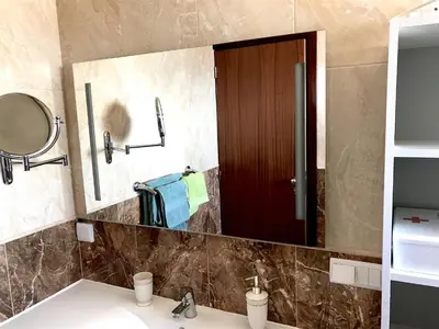 a bathroom with a sink and a mirror at Apartamento Romantico in Caniço