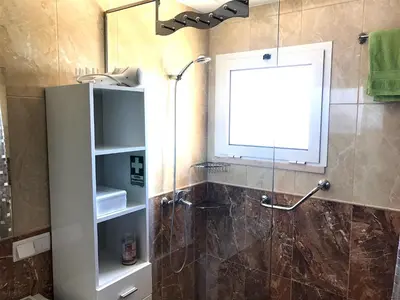 a bathroom with a shower with a glass door at Apartamento Romantico in Caniço