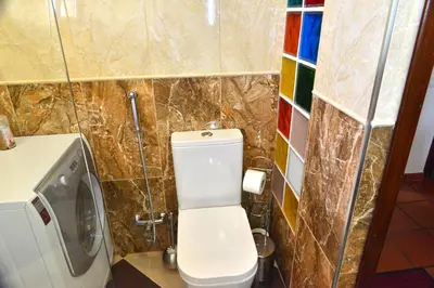 a small bathroom with a toilet and a sink at Apartamento Romantico in Caniço