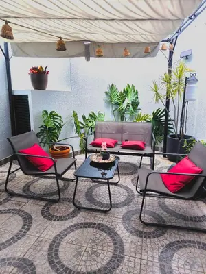 a group of chairs and tables in a room with plants at Old Town House Madeira in Funchal