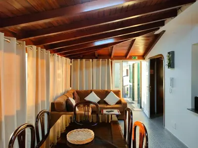 a living room with a couch and a table at Rochinha House in Funchal
