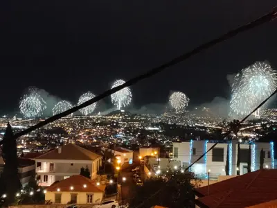 a fireworks display over a city at night at Rochinha House in Funchal