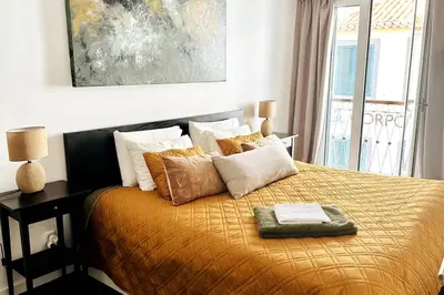 a bedroom with a bed with a yellow blanket and pillows at Artist Loft - Modern Stay in Historic Old Town in Funchal