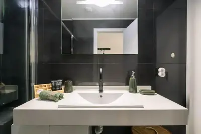 a coffee maker sitting on a counter with a glass at Artist Loft - Modern Stay in Historic Old Town in Funchal