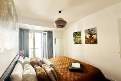 a bedroom with a bed with pillows and a painting at Artist Loft - Modern Stay in Historic Old Town in Funchal