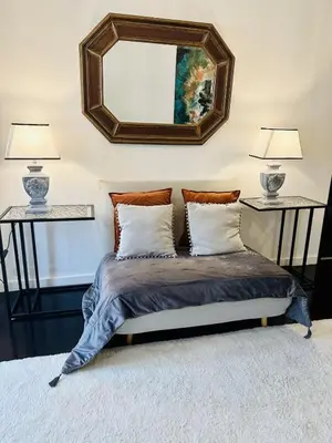 a room with a television and two paintings on the wall at Artist Loft - Modern Stay in Historic Old Town in Funchal