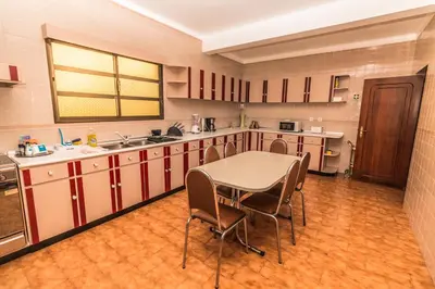 a kitchen with a table and chairs in a room at Monte Vista Hermosa in Funchal