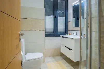 a bathroom with a toilet and a sink at Enxurros House in Ponta Delgada