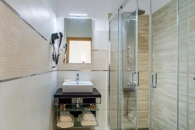 a bathroom with a sink and a shower at Enxurros House in Ponta Delgada