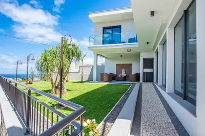 a villa with a view of the ocean at Enxurros House in Ponta Delgada