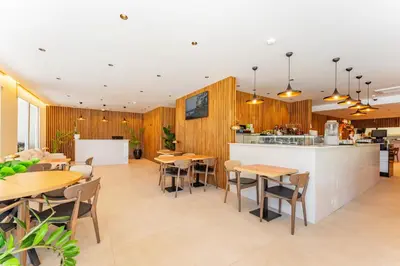 a restaurant with wooden walls and tables and chairs at Vila Baleira Residence in Funchal