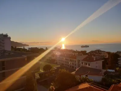a view of the sunset over a city at GuestHouse Vila Lusitania in Funchal