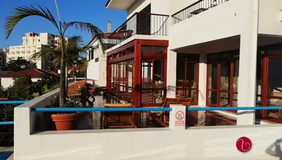 a view of a house with a pool at GuestHouse Vila Lusitania in Funchal
