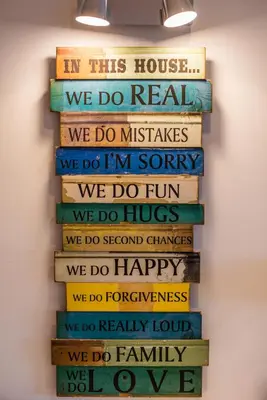 a stack of books with the words in this house we do realwe do mistakes at The Bay View - by LovelyStay in Funchal