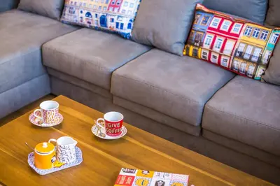 two cups of coffee on a table in front of a couch at The Bay View - by LovelyStay in Funchal
