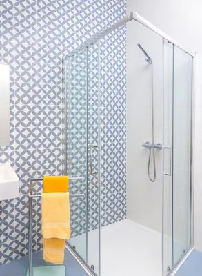 a shower with a glass door in a bathroom at Endless Blue House in Arco da Calheta