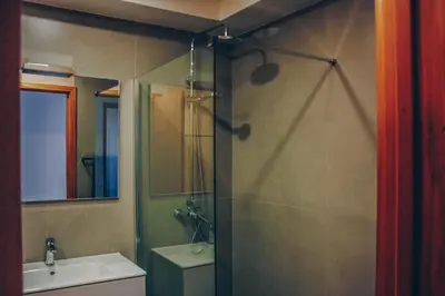 a bathroom with a shower and a sink at Horizon View Madeira in Caniço