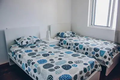 two beds sitting next to each other in a bedroom at Horizon View Madeira in Caniço