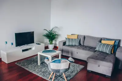 a living room with a couch and a tv at Horizon View Madeira in Caniço