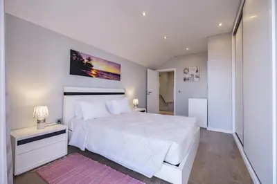 a bedroom with a large white bed with a white bedspread at Vivenda da Natureza in Santa Cruz