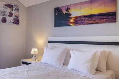 a bedroom with a bed with white pillows at Vivenda da Natureza in Santa Cruz