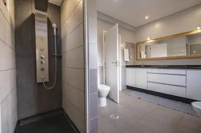 a bathroom with a toilet and a sink at Vivenda da Natureza in Santa Cruz