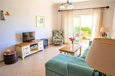 a living room with a couch and a tv at Boavista Fairviews Village in Lagos