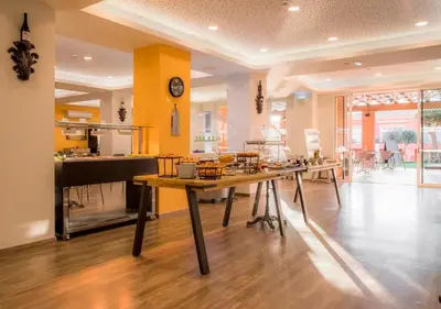 a kitchen with a table and a dining room at Boavista Fairviews Village in Lagos