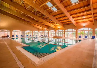 a large indoor pool in a building with windows at Boavista Fairviews Village in Lagos