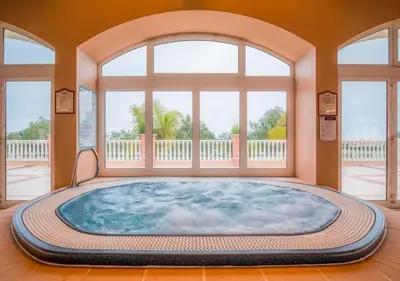 a large tub in a room with a large window at Boavista Fairviews Village in Lagos